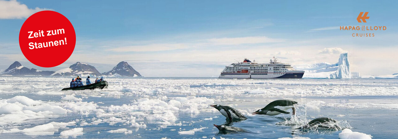 Schiff von Hapag-Lloyd in der Antarktis mit Pinguinen und Zodiac symbolisiert Kreuzfahrten